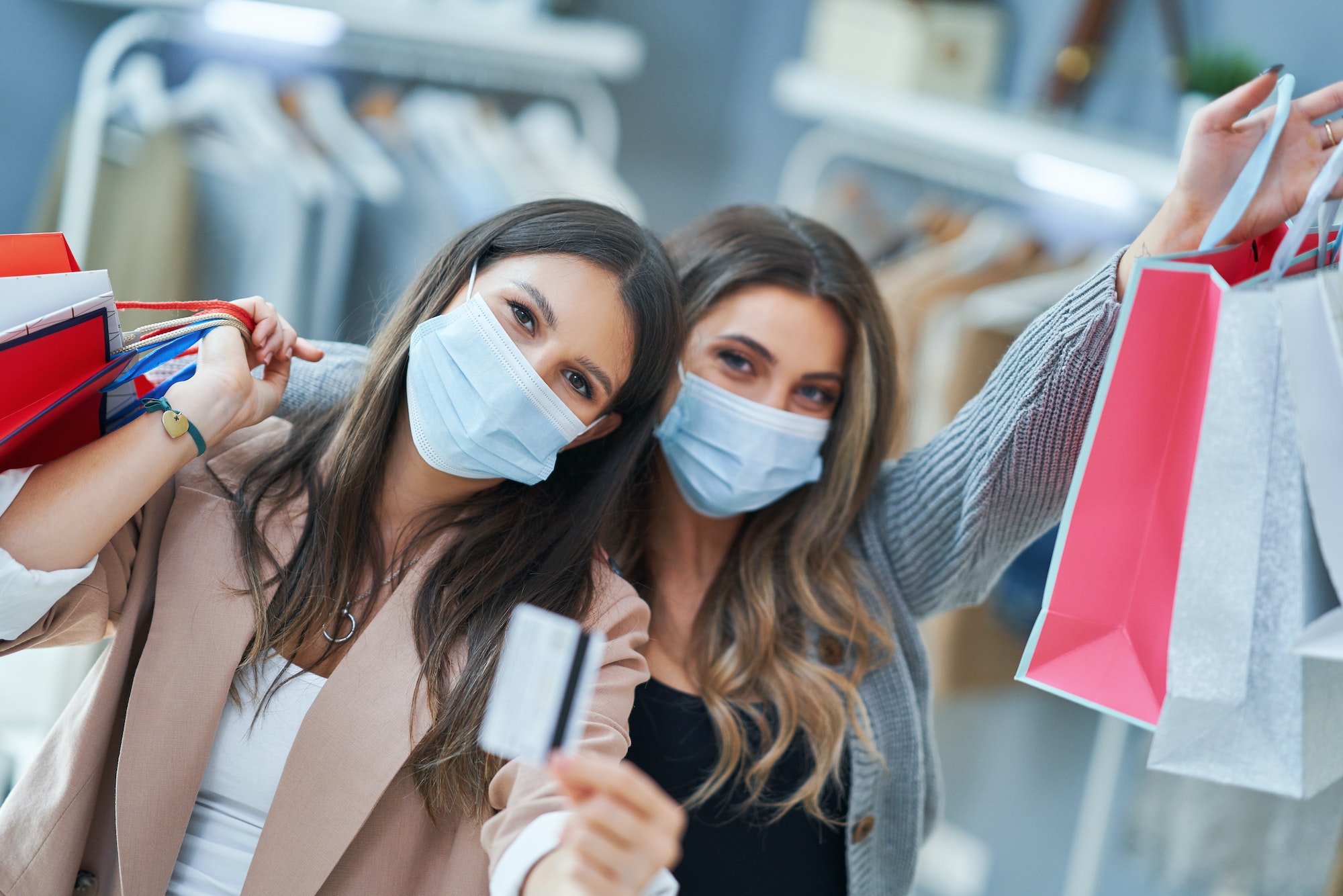 Girls on shopping in clothes store